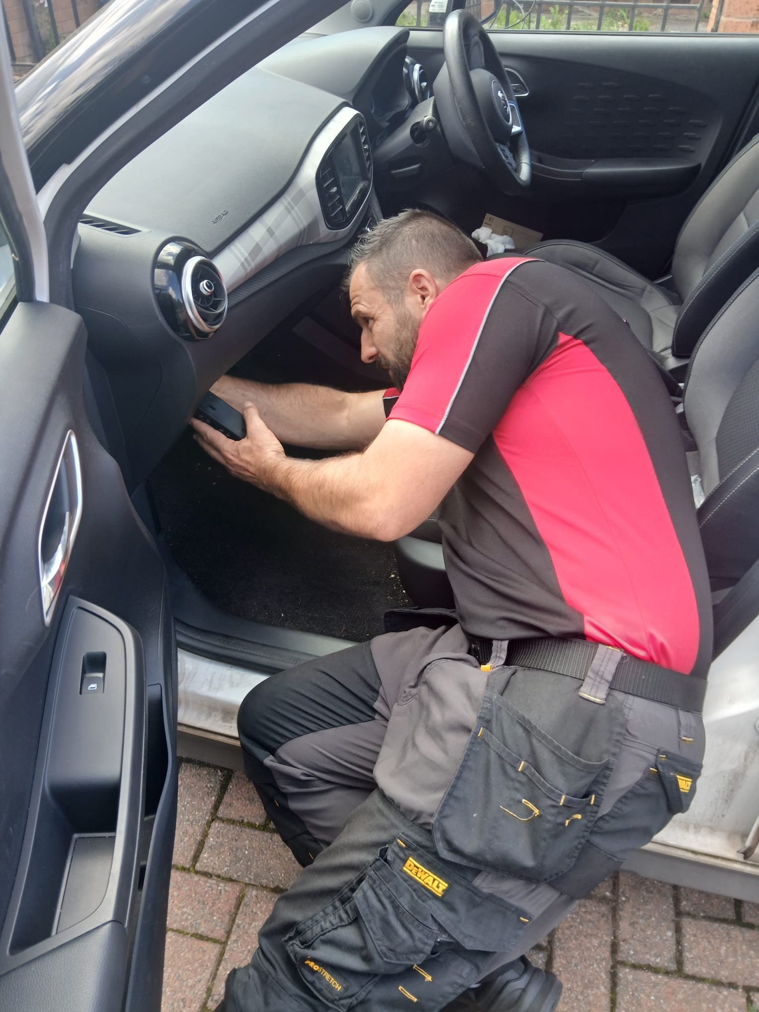 Craig Evans programming a car key at a customer's vehicle