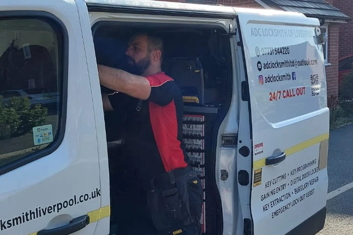 Craig Evans at the side door of the ADC Locksmith van