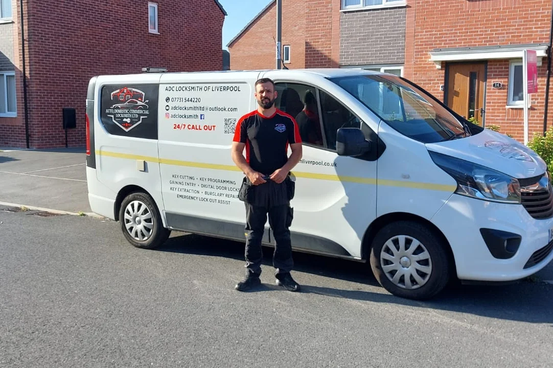 Craig Evans, the ADC locksmith who attends each job, beside the van