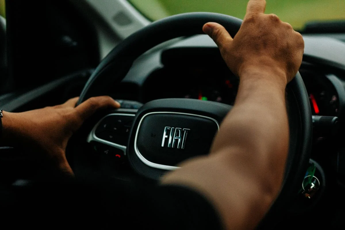 Hands on a Fiat steering wheel