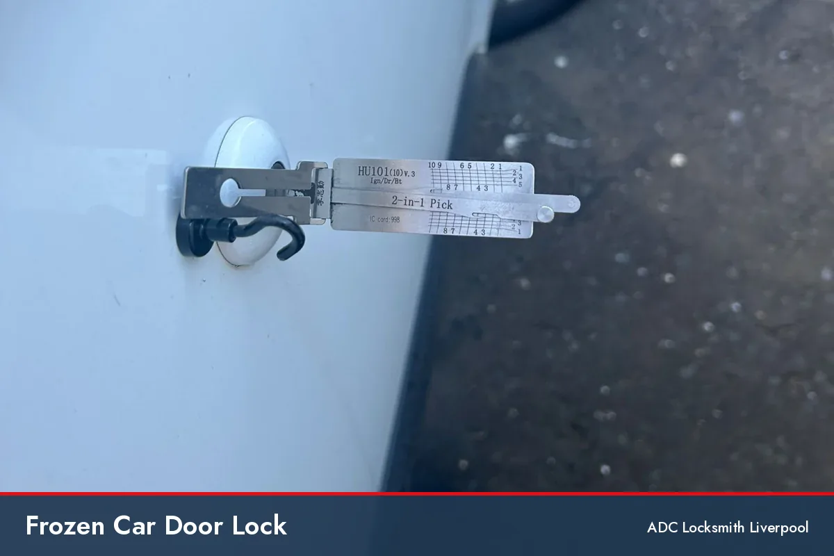 frozen car door lock, locksmith tool in the door lock of a white car