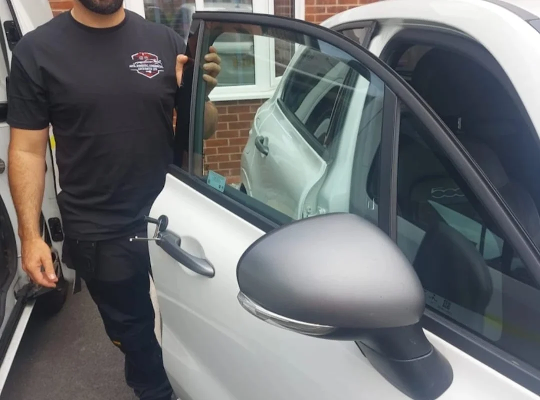 Craig Evans beside a customer car with the door open