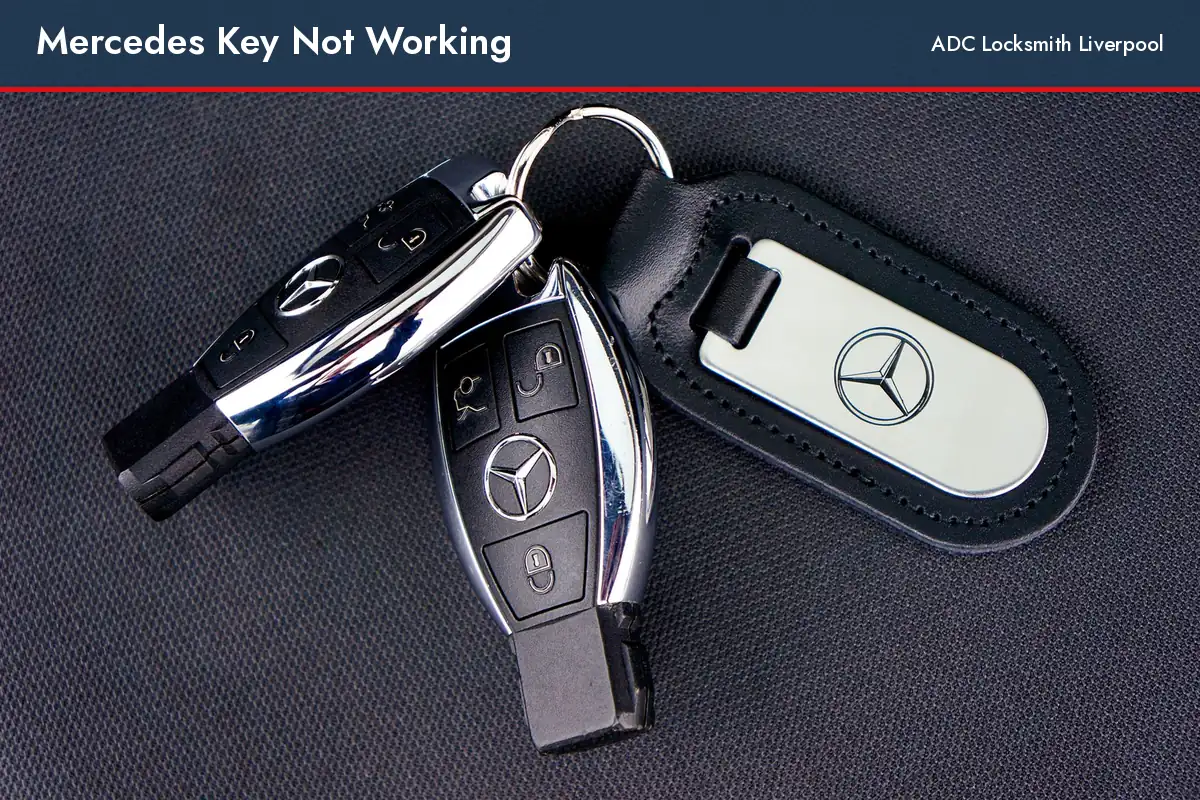 Mercedes key not working, two Mercedes keys with a key ring on dark fabric